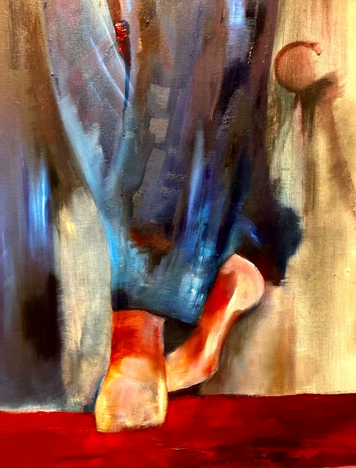 Rode schoenen: voeten in rode schoenen onder een blauw gewaad, op een dieprode vloer.